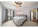 Serene bedroom with a queen-size bed and backyard view at 9203 Sea Oaks Ct, Seminole, FL 33776