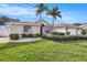 Exterior view of house, showcasing landscaping and garage at 9203 Sea Oaks Ct, Seminole, FL 33776