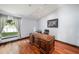 Bright home office with hardwood floors and built-in bookcases at 9203 Sea Oaks Ct, Seminole, FL 33776