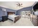 Spacious main bedroom with private access to the pool and a ceiling fan at 9203 Sea Oaks Ct, Seminole, FL 33776