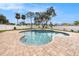 Freeform swimming pool with large patio and fire pit at 9203 Sea Oaks Ct, Seminole, FL 33776