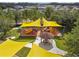 Aerial view of a playground with yellow shade sails and a gazebo at 9846 Red Bay Loop, Land O Lakes, FL 34637