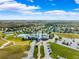 Aerial view of community with pools, tennis courts, and clubhouse at 9846 Red Bay Loop, Land O Lakes, FL 34637