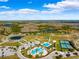 Aerial view showing community amenities including pools and tennis courts at 9846 Red Bay Loop, Land O Lakes, FL 34637