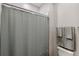 Clean bathroom with shower, toilet and gray shower curtain at 9846 Red Bay Loop, Land O Lakes, FL 34637