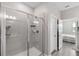 Bright bathroom featuring a walk-in shower and gray tile at 9846 Red Bay Loop, Land O Lakes, FL 34637