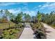 Dog park entrance with gate, landscaping, and walking path at 9846 Red Bay Loop, Land O Lakes, FL 34637