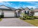 Two-story house with gray siding and brick driveway at 9846 Red Bay Loop, Land O Lakes, FL 34637