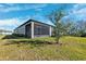 Exterior view of home with screened porch and yard at 9846 Red Bay Loop, Land O Lakes, FL 34637