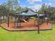 Community playground with shade structures, swings, and playset at 9846 Red Bay Loop, Land O Lakes, FL 34637