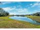 Scenic pond view with reflection of homes at 9846 Red Bay Loop, Land O Lakes, FL 34637