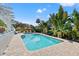 Inviting rectangular pool surrounded by lush landscaping at 1 Gallinule Pl, Belleair, FL 33756