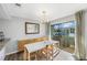 Modern dining room with white table and access to a patio at 1 Windrush Blvd # 100, Indian Rocks Beach, FL 33785