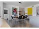 Modern dining room with wood table and black chairs, artwork, and open floor plan at 100 1St N Ave # 503, St Petersburg, FL 33701