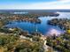 Wide aerial view of lakefront home and surrounding neighborhood at 10106 Tarpon Springs Rd, Odessa, FL 33556