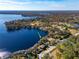 Aerial view of waterfront home with lush landscape, showcasing a peaceful lakeside setting at 10106 Tarpon Springs Rd, Odessa, FL 33556