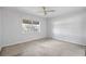 Simple bedroom with ceiling fan and window at 10106 Tarpon Springs Rd, Odessa, FL 33556