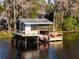 Waterfront boathouse with boat lift, perfect for water activities at 10106 Tarpon Springs Rd, Odessa, FL 33556