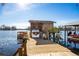 Wooden boat lift with a covered boathouse and dock at 10106 Tarpon Springs Rd, Odessa, FL 33556