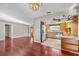 Kitchen with light wood cabinets, a breakfast bar and view into the living room at 10106 Tarpon Springs Rd, Odessa, FL 33556