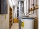 Utility room with water heater and shelving at 10106 Tarpon Springs Rd, Odessa, FL 33556