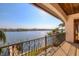 Covered balcony with decorative railing overlooks the water, offering expansive views at 1097 Eden Isle Ne Dr, St Petersburg, FL 33704