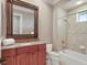 Bathroom featuring a single sink vanity with granite counters, tub, and tiled shower at 1097 Eden Isle Ne Dr, St Petersburg, FL 33704