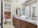 Bathroom features a marble double sink vanity, a large mirror, and linen storage at 1097 Eden Isle Ne Dr, St Petersburg, FL 33704