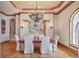 Dining room featuring decorative columns and a stunning chandelier at 1097 Eden Isle Ne Dr, St Petersburg, FL 33704