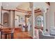 Elegant dining room with hardwood floors, decorative columns, and waterfront view at 1097 Eden Isle Ne Dr, St Petersburg, FL 33704