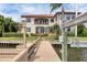 Waterfront home featuring a private dock, boat lift and luxurious backyard landscaping at 1097 Eden Isle Ne Dr, St Petersburg, FL 33704