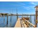 A private wooden dock extends into the water, offering picturesque waterfront views at 1097 Eden Isle Ne Dr, St Petersburg, FL 33704