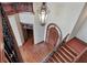 An overhead view of the foyer with a wood door, staircase, and hardwood floors at 1097 Eden Isle Ne Dr, St Petersburg, FL 33704