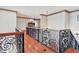 Hallway with decorative wrought iron railing and hardwood floors at 1097 Eden Isle Ne Dr, St Petersburg, FL 33704