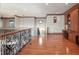 A hallway with hardwood floors, decorative wrought iron railing, and a built-in desk area at 1097 Eden Isle Ne Dr, St Petersburg, FL 33704