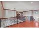 A hallway with hardwood floors and decorative wrought iron railing overlooking downstairs at 1097 Eden Isle Ne Dr, St Petersburg, FL 33704