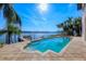 Backyard view with large swimming pool and jacuzzi overlooking the water with a private dock at 1097 Eden Isle Ne Dr, St Petersburg, FL 33704