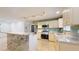 Modern kitchen with granite island, stainless steel appliances, and tiled backsplash at 1130 Queen N St, St Petersburg, FL 33713