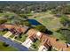 Community overview featuring villas, golf course, and pond at 1162 Rustlewood Ct, Palm Harbor, FL 34684