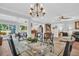 Elegant dining room with glass table and chandelier at 1162 Rustlewood Ct, Palm Harbor, FL 34684