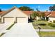 Two-car garage and attractive landscaping at 1162 Rustlewood Ct, Palm Harbor, FL 34684