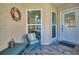 Inviting front porch with wicker chair and decorative wreath at 1162 Rustlewood Ct, Palm Harbor, FL 34684