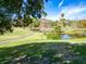 Landscaped golf course with pond and walking path at 1162 Rustlewood Ct, Palm Harbor, FL 34684