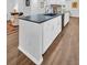 Spacious kitchen island with dark countertop and white cabinets at 1162 Rustlewood Ct, Palm Harbor, FL 34684