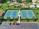 Aerial view of well-maintained tennis courts with ample parking at 1162 Rustlewood Ct, Palm Harbor, FL 34684