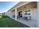 Covered patio with seating and yard view at 13305 Waterleaf Garden Cir, Riverview, FL 33579