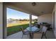 Covered patio with seating area and pond view at 13305 Waterleaf Garden Cir, Riverview, FL 33579