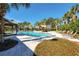 Relaxing community pool with palm trees and shaded areas at 13305 Waterleaf Garden Cir, Riverview, FL 33579