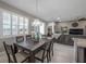 Open dining room with six-chair table and view to the kitchen at 13305 Waterleaf Garden Cir, Riverview, FL 33579