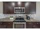 Modern kitchen with stainless steel appliances and granite countertops at 13305 Waterleaf Garden Cir, Riverview, FL 33579